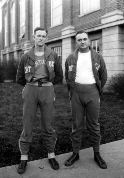 Coach Adolph Rupp and unidentified player, in front of Alumni Gym