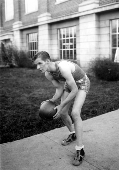 Basketball player in front of Alumni Gym
