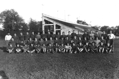 Kentucky football team in front of stands of McLean Stadium