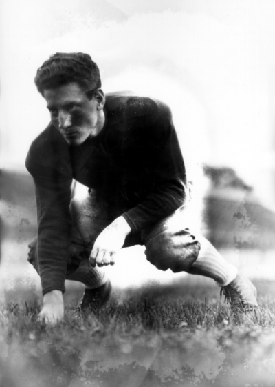 Kentucky football player, in three point stance position