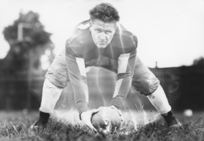 Kentucky football player in position to snap the ball