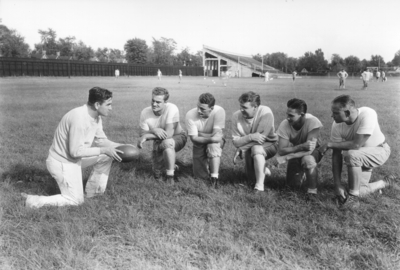 Football players, McLean Stadium in background