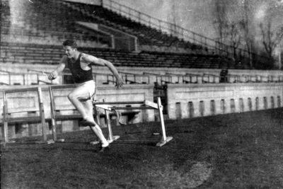 University of Kentucky men's track team member, jumping hurdles, McLean Stadium