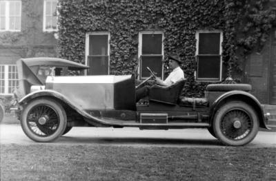 Charles H. Anderson, Professor of Engineering Design, 1919 - 1938 seated in his 1921 Rolls Royce car in front of Kinkead Hall
