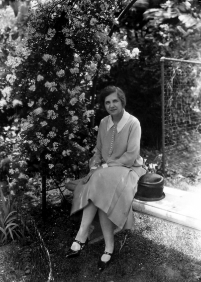 Miss, Ethel Jelley, secretary to Dean of Engineering, F. Paul Anderson, seated on a bench