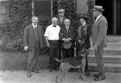 Dean F. Paul Anderson, Engineering in white shirt, with four men, a woman, and his dog 