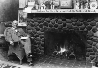 Dean F. Paul Anderson, Engineering, seated by fireplace in Dicker Hall, Christmas Card, 1929