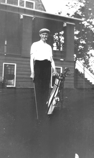 Unidentified man with golf clubs