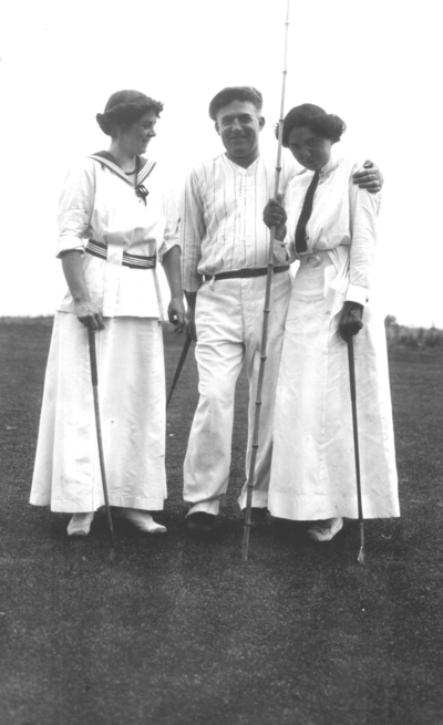 Two unidentified women, one unidentified man with golf clubs