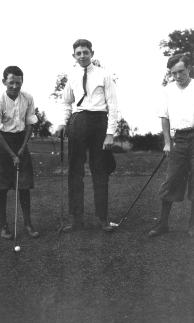 Three young men golfing