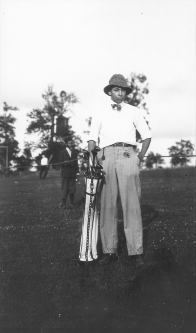Unidentified man with golf clubs