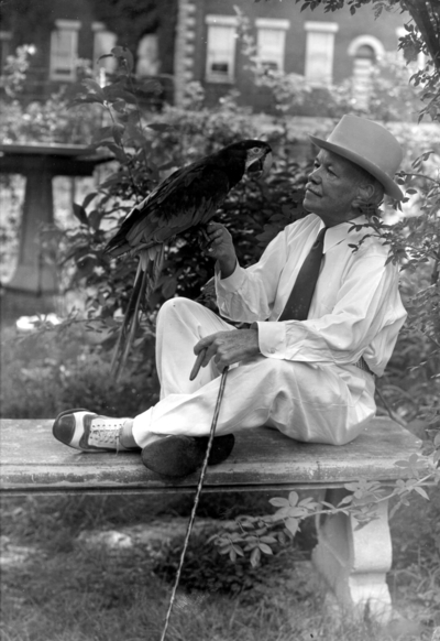 Dean F. Paul Anderson, Engineering, on a bench with a parrot