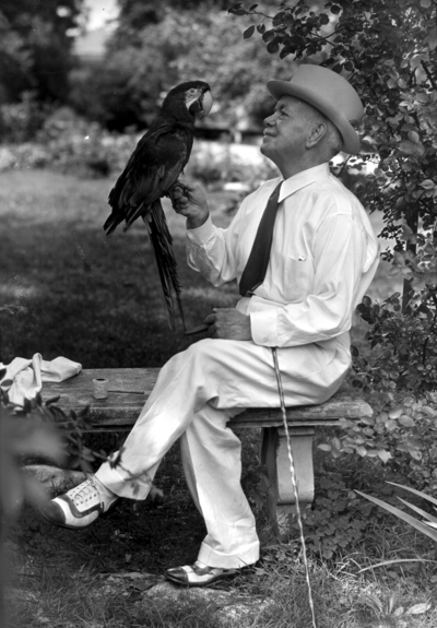 Dean F. Paul Anderson, Engineering, on a bench with a parrot