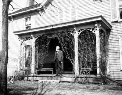 Unidentified old man standing on porch, Joseph Dicker Family? superintendent of shops