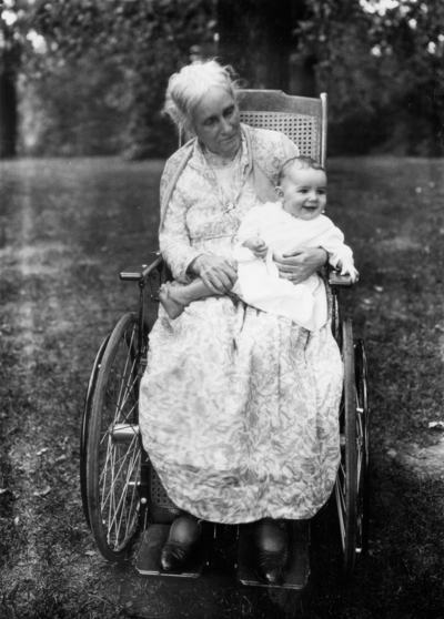 Frank L. McVey's mother in wheelchair holding an infant