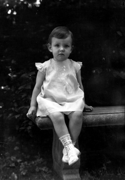 Family of President Frank L. McVey, 1917-1940, McVey grandchild seated on a bench