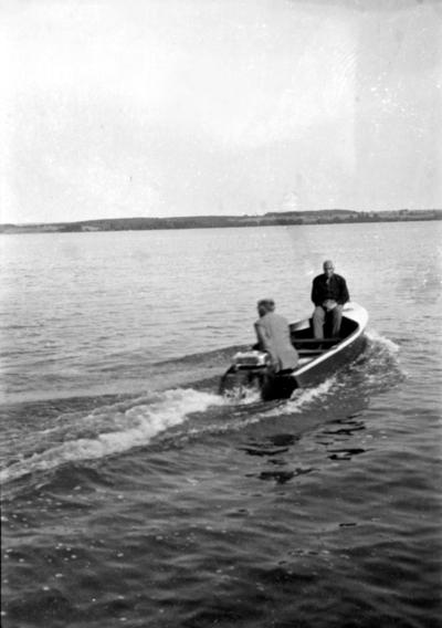 Two unidentified people on small boat