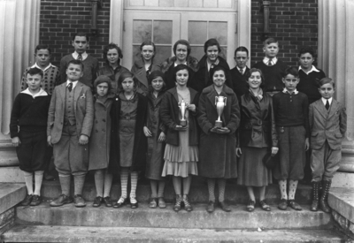 Unidentified grade school class, two with trophies