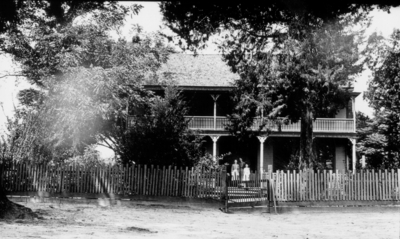 House with 2-story porch and picket fence