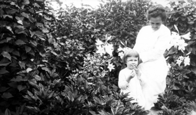 Unidentified woman and child in garden