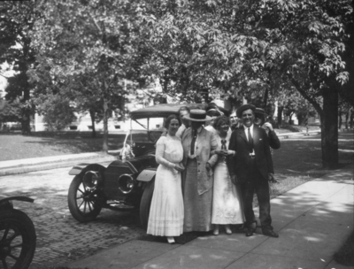 Unidentified group of people by Model T car