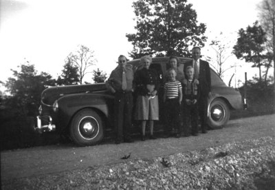 Six unidentified people in front of car