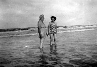 Two unidentified women wading in ocean