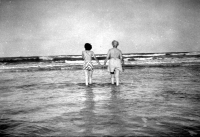 Two unidentified women wading in ocean