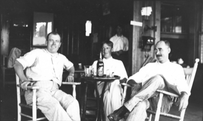 Three unidentified men seated