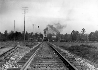Train, smokestack, in the distance