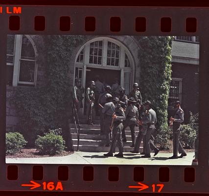 Groups of people and soldiers in front of Buell Armory