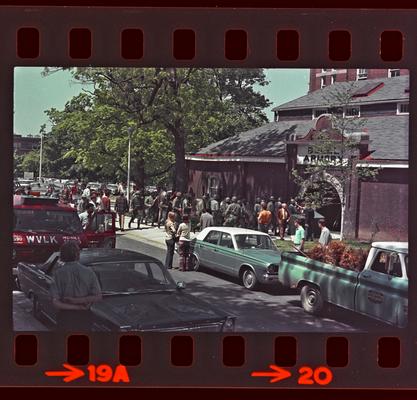 Groups of people and soldiers in front of Buell Armory