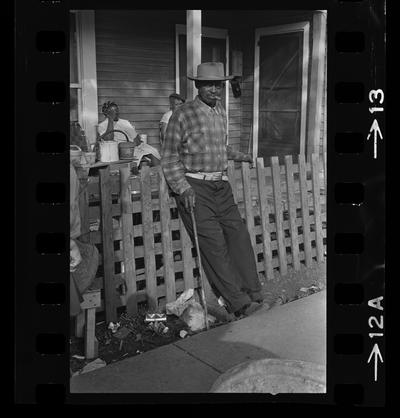 Man leaning on fence, Three children