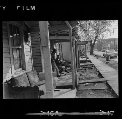 Two men on porch, Three children