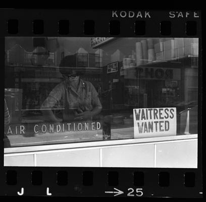 Two men in front of building, Waitress working in a cafe