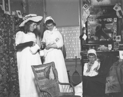 3 people dressed in what appear to be costumes and play acting