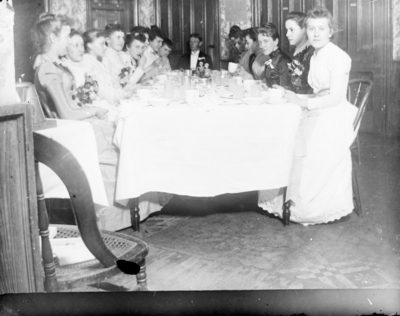a group  sitting at a table ready to eat