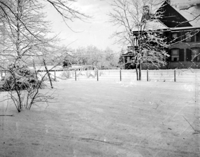 snow scene with a house in the background