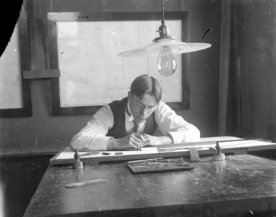 a man drafting at a table