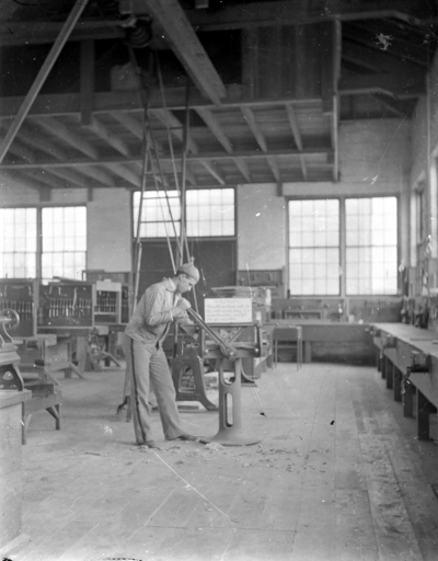 a man working with tools on machinery