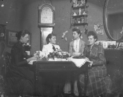 4 women sitting around a table