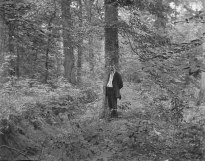 a man standing in a wooded area