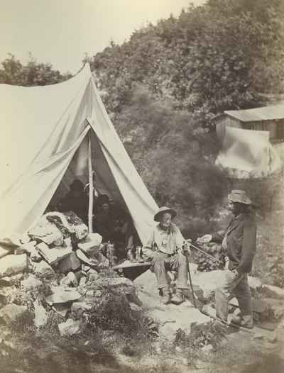 Unidentified men around a tent. Caption reads 