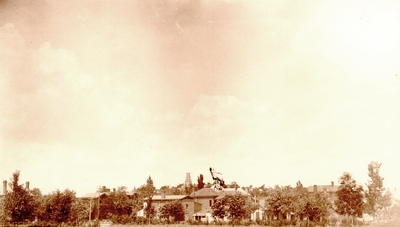 View of sky; Large houses among trees at bottom