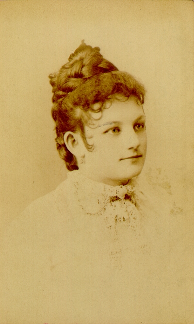 Young woman with fancy lace shirt and fancy hair