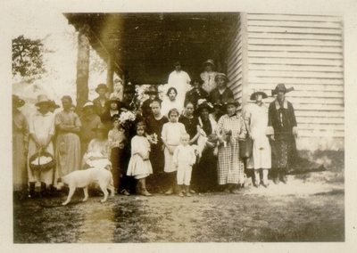 Large group standing on side of porch