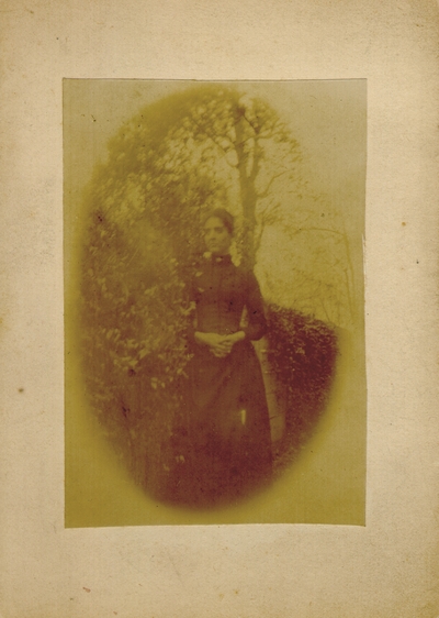 Young woman standing near tree