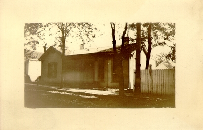 Small house off of street; Fence is gone and telephone poll has been erected