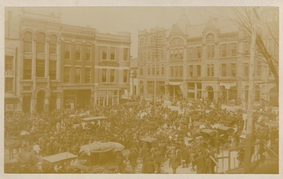 View of Cheapside and Short, taken from courthouse; Hundreds of people gathered in street with horses and carriages