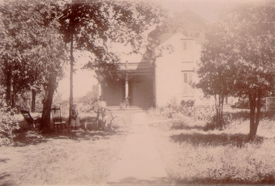 Two-story house with walkway leading to porch
